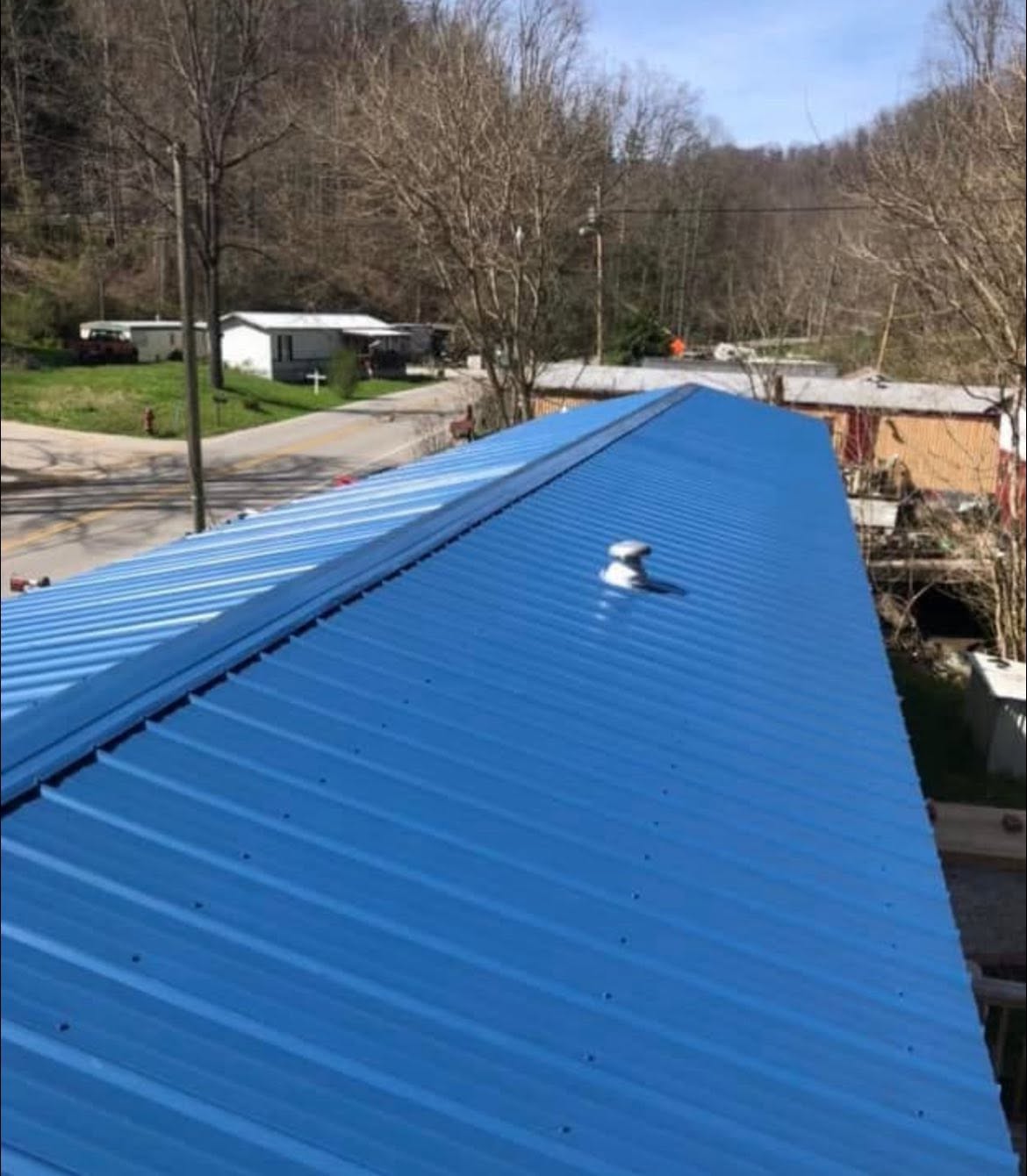Bright blue exposed-fastener roof